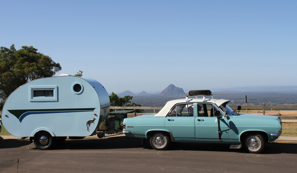 blue retro car and trailer from vintage caravan style book