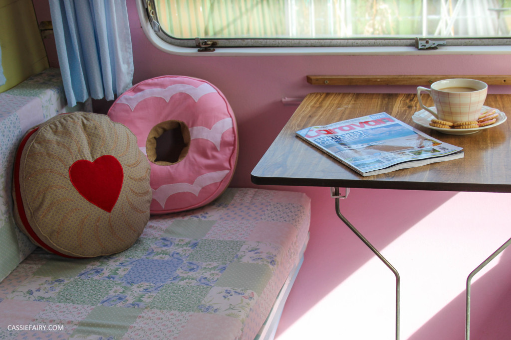 vintage caravan interior with biscuit cushions and cat-13