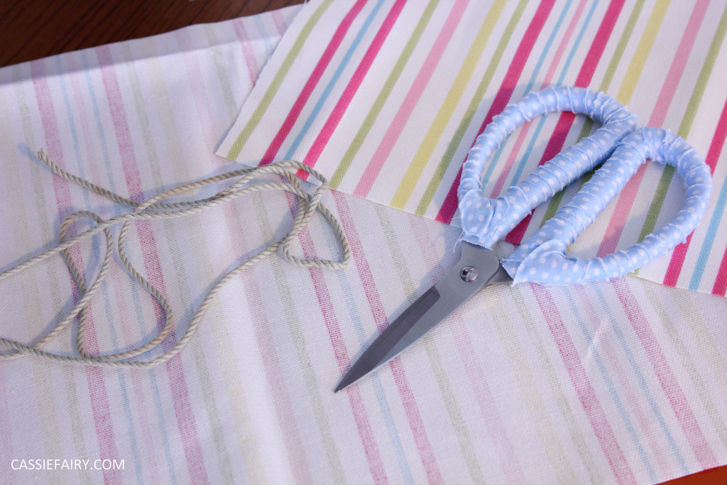 Photo of striped fabric and thread with a pair of scissors