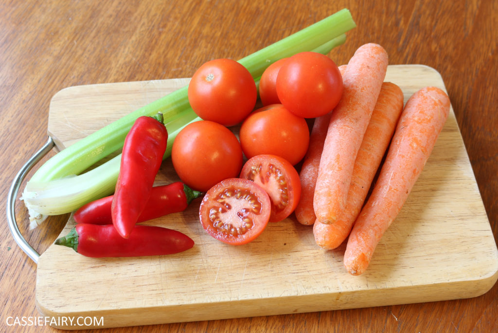 photo of carrots, tomatoes, celery and peppers on a chopping board 