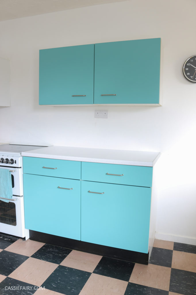Kitchen cabinets painted in turquoise blue with vintage style white oven 