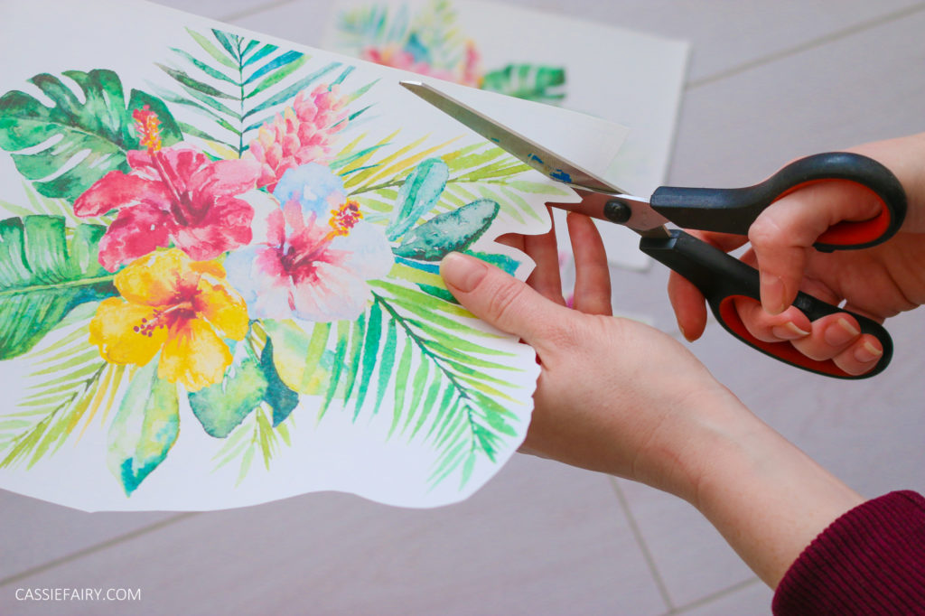 Iron-on transfer paper printed with a tropical design, being cut out around the leaves.