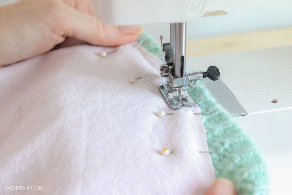 Photo of pink and green fabric being stitched together with a sewing machine