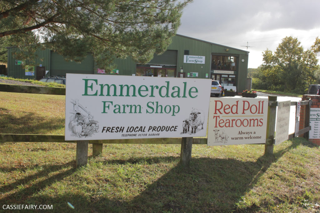 The front of a farm shop with signs outside 