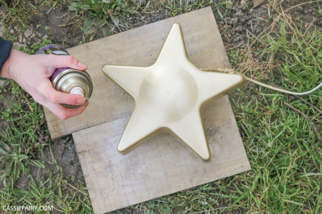 spray painting a silver star lamp with gold spray paint