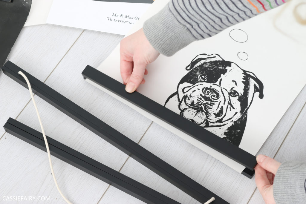 magnetic hanging frame being applied to lino print of a dog