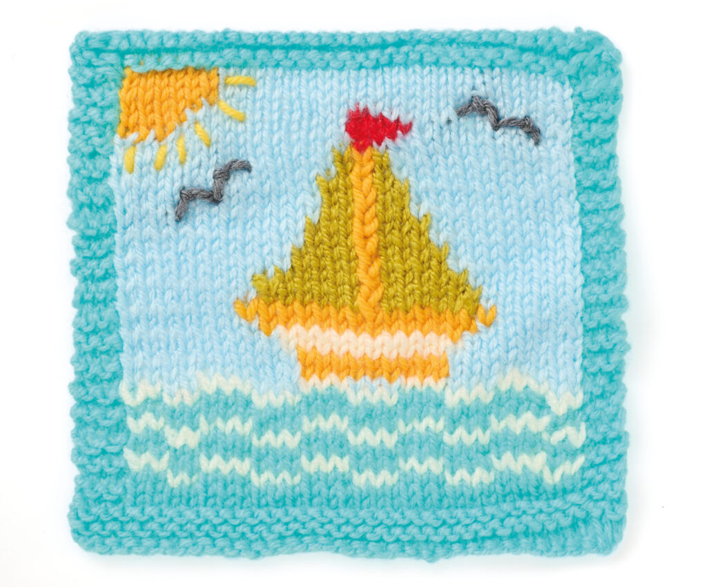Intarsia motif of sailing boat and waves