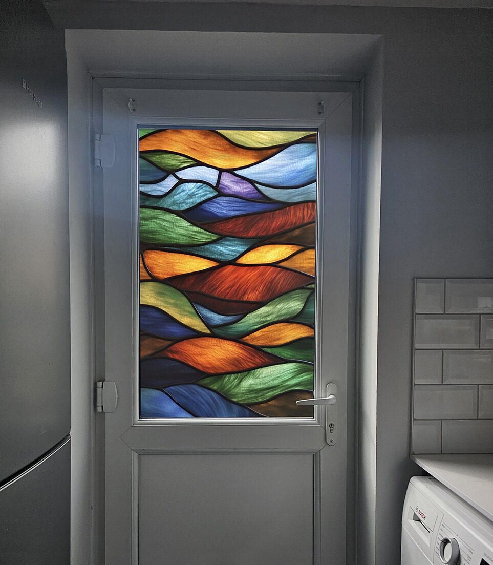 A stained glass effect window film in autumnal colours on a glazed back door by Signs For You.