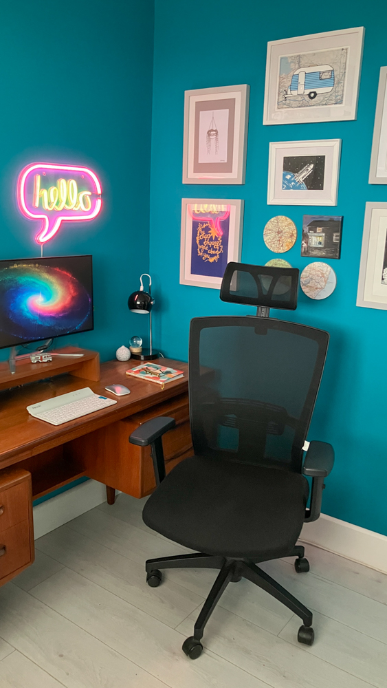 My 60s space-race home office with teal walls, a teak G-Plan desk and a black ergonomic desk chair.