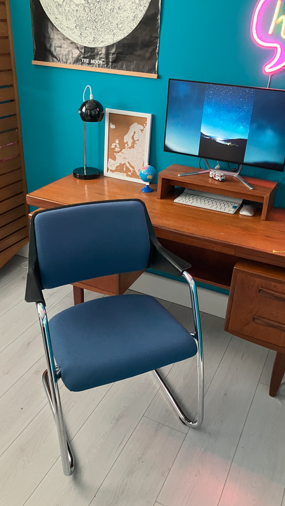 My 60s space-race home office with teal walls, a teak G-Plan desk and a blue and chrome Girsberger desk chair.