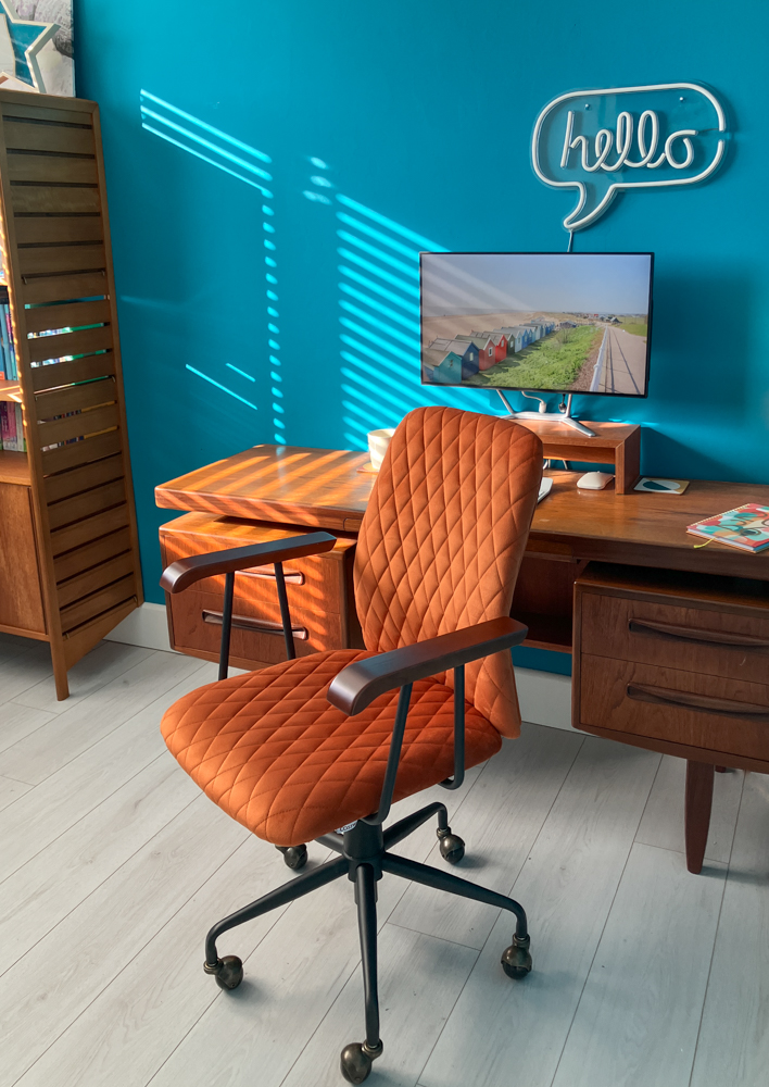 My 60s mid century home office with teal walls, a teak G-Plan desk and a padded orange velvet desk chair.