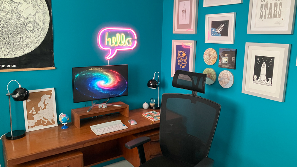 My 60s space-race home office with teal walls, a teak G-Plan desk and a black ergonomic desk chair.